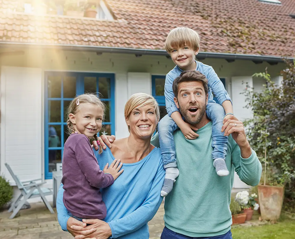 Family outside their Dearborn home protected by comprehensive property and life insurance.