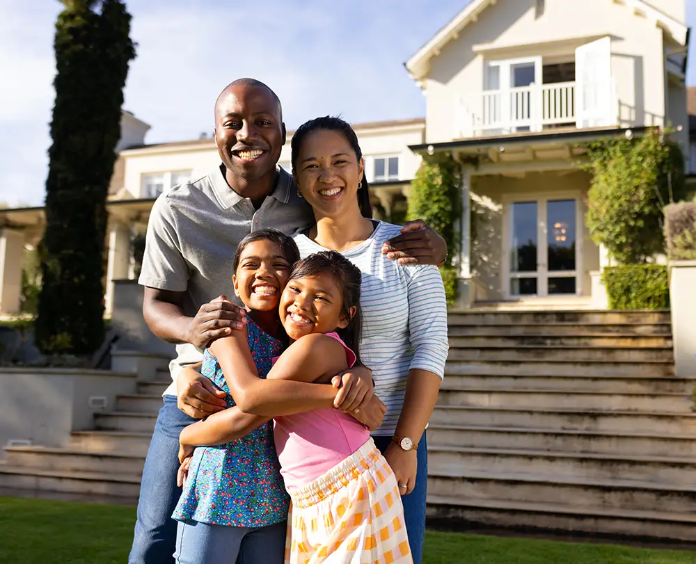 Family outside their Southfield home protected by comprehensive property and life insurance.