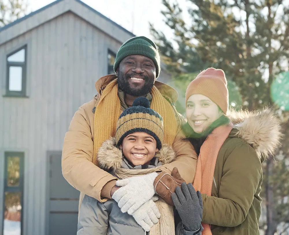 Family outside their Warren home protected by comprehensive property and life insurance
